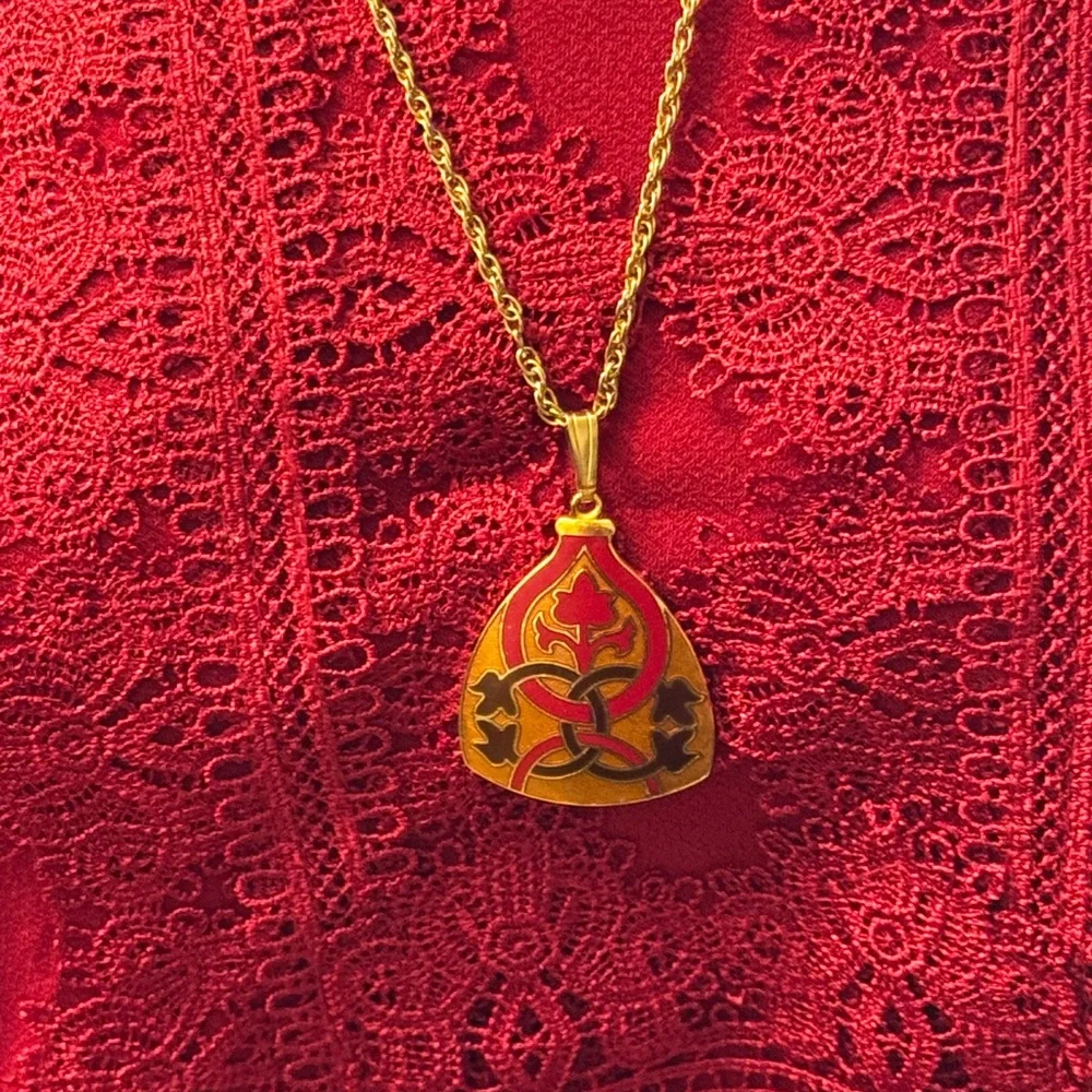 Gold tone signed Celtic knot pendant necklace in red, black and orange enamel